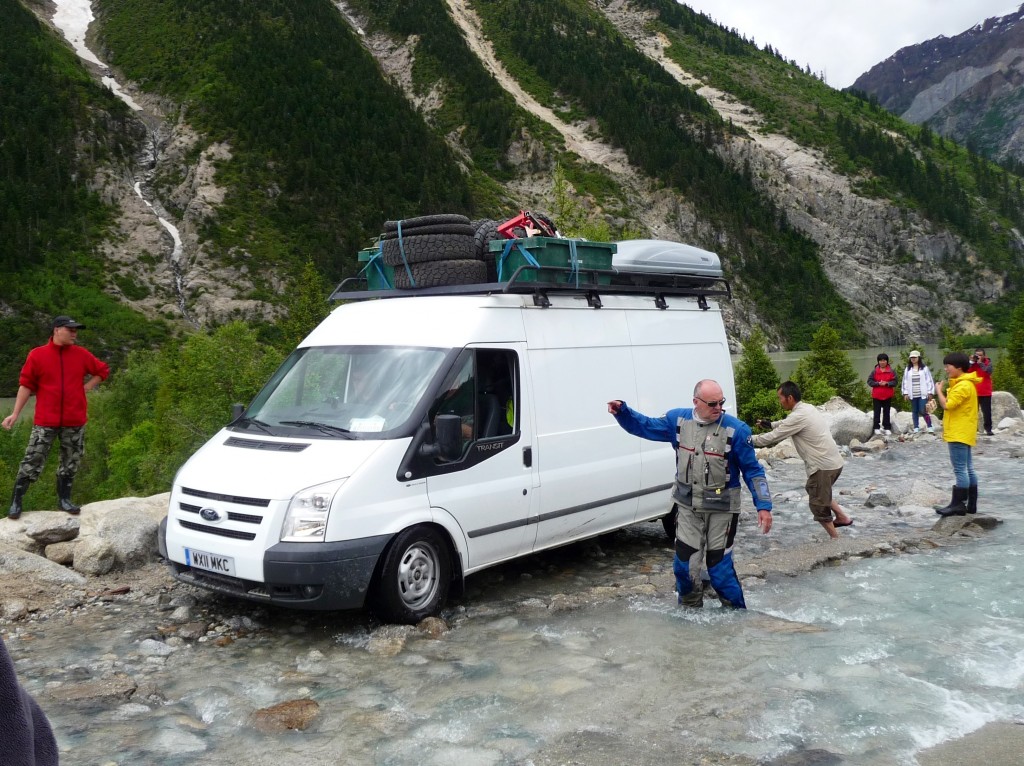 Van crossing flooded road